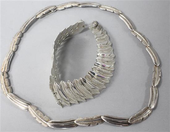 A contemporary silver feather necklace and matching bracelet.